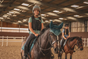 Child builds confidence and skill through weekly horse riding lessons at Lavant Equestrian near Chichester.