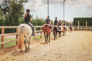 Child builds confidence and skill through weekly horse riding lessons at Lavant Equestrian near Chichester.