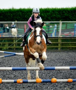 Child horse jumping at Lavant Equestrian