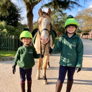 Children outdoors with horse