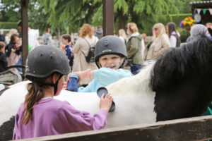 Kids learning to groom a pony